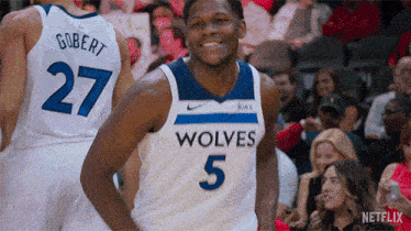 a basketball player wearing a jersey that says wolves