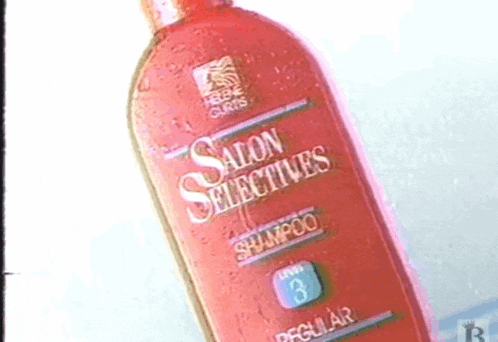 a red bottle of salon selectives shampoo is sitting on a white surface