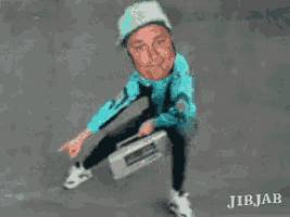 a man in a green hat is holding a boombox in his hand