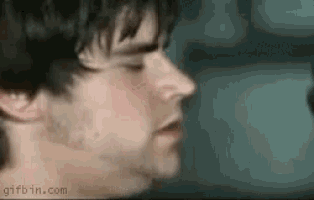 a close up of a man 's face with his eyes closed and a blurry background .
