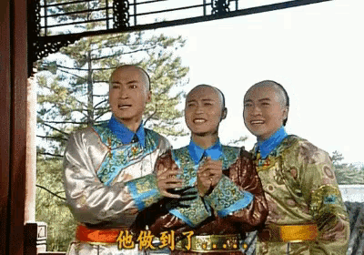 three men standing next to each other with chinese writing on the bottom right