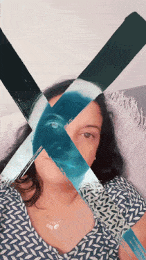 a woman is laying on a couch with a painting of her face