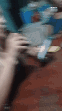 a blurry image of a person drinking from a bottle