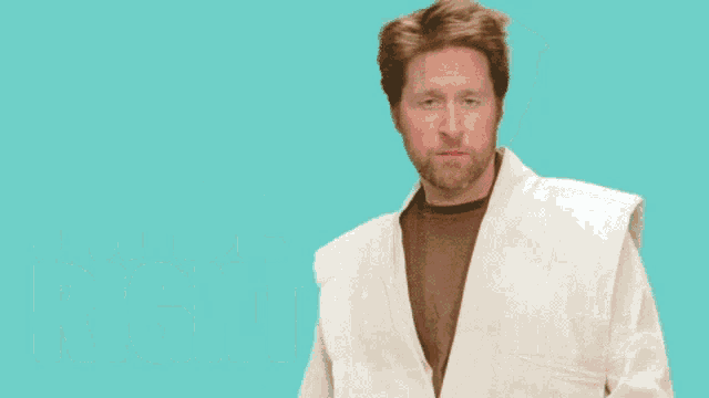 a man in a robe says i 'll be right while pointing
