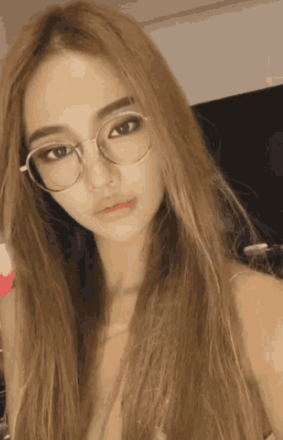 a woman with long blonde hair wearing glasses