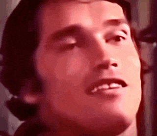 a close up of a man 's face with a microphone in front of him .