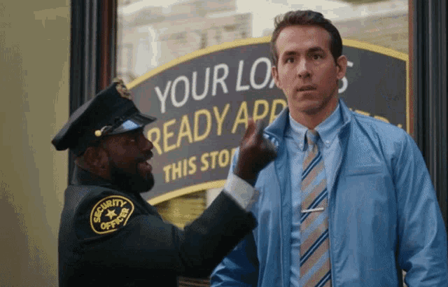 a security guard points at a man in front of a sign that says your loan ready app
