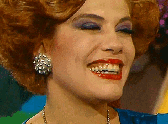 a close up of a woman 's face with a big smile