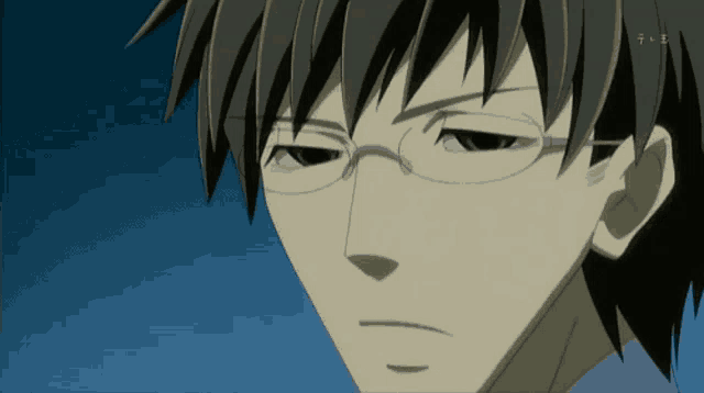 a close up of a man 's face with glasses and a blue sky behind him
