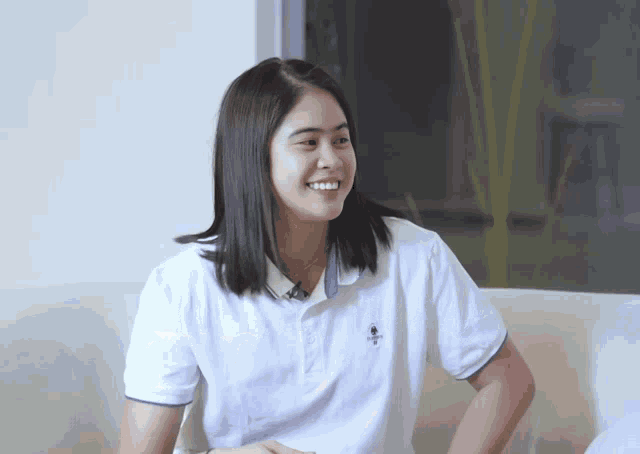 a woman wearing a polo shirt that says ' us polo assn ' on the front
