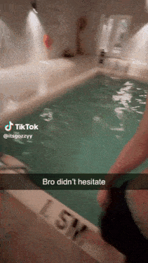 a person is standing next to a swimming pool with a caption that says bro did n't hesitate .