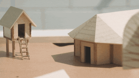 a wooden model of a house with a ladder