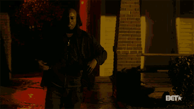 a man is standing in front of a brick building with the words fine as hell below him