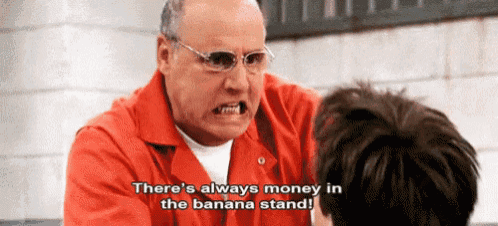 a man in an orange jumpsuit is talking to another man and says there 's always money in the banana stand !