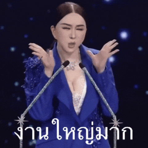a woman in a blue jacket stands in front of a microphone with her hands in the air ..