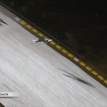 a person is skiing down a snow covered slope with the words km / h on the bottom