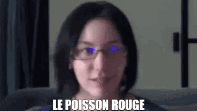 a woman wearing glasses and a blue shirt with the words le poisson rouge written on her face .