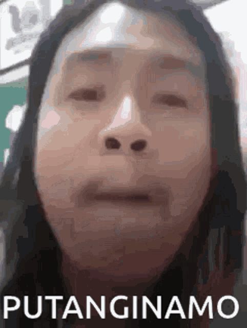 a close up of a woman 's face with the words putanginamo written on the bottom .