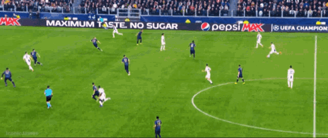 a soccer game is being played on a field with santander advertisements