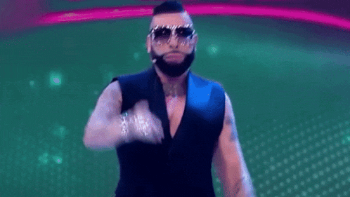 a man with a beard wearing sunglasses and a suit is dancing .