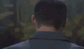a blurry picture of a man 's face is behind a glass .