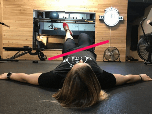 a woman is laying on the floor with her arms outstretched and a shirt that says fit club on it