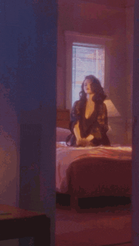 a woman with red lips and a ring on her finger is talking on a cell phone