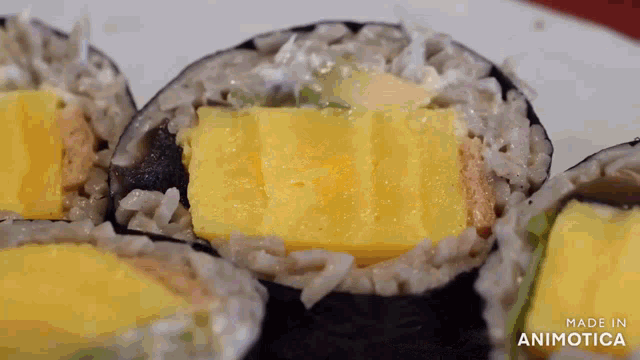 a close up of a sushi roll with the words made in animotica visible