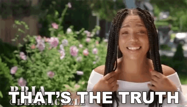 a woman with braids is smiling with the words that 's the truth behind her .