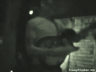 a man is playing a guitar in a dark room in a blurry photo .