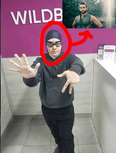 a man standing in front of a sign that says wildb on it