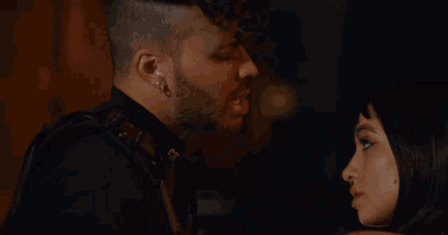 a man and a woman are looking at each other with their eyes closed
