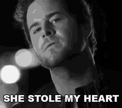 a black and white photo of a man with the words she stole my heart above him