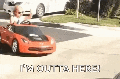 a man is driving a toy car down a street .