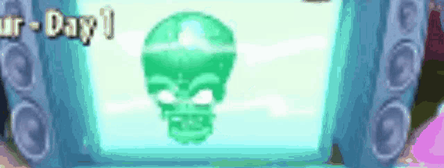 a green skull is displayed on a screen next to speakers