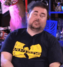 a man with a beard wearing a wu tang t-shirt