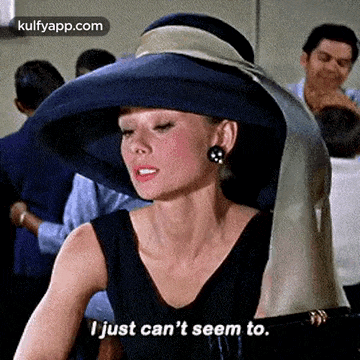 audrey hepburn is wearing a blue hat and a black dress and says `` i just can 't seem to . ''