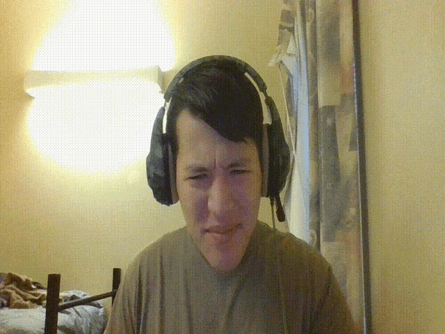 a man wearing headphones and a microphone makes a funny face