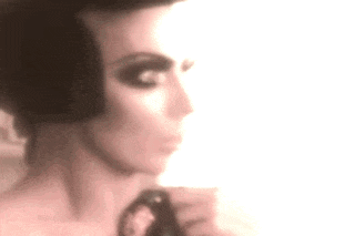 a blurry picture of a woman 's face with a very dark eye makeup