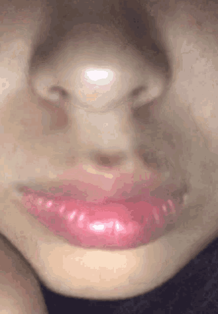 a close up of a woman 's face with pink lips and a nose