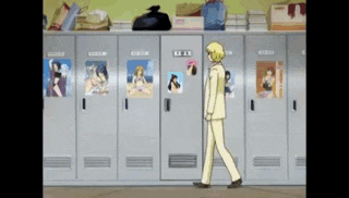 a man in a suit is walking in front of a row of lockers with pictures of women on them