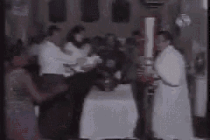 a group of people are standing around a table .