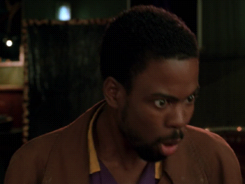 a man with a beard is making a funny face with his mouth open .