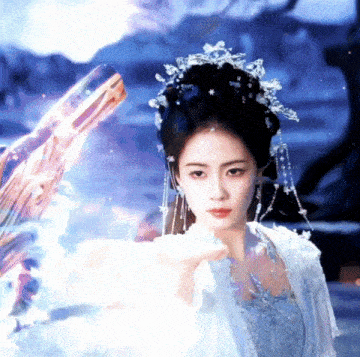 a woman in a white dress and a crown is holding a white object .