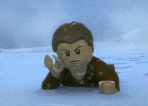 a lego figure is laying in the snow with a serious look on his face