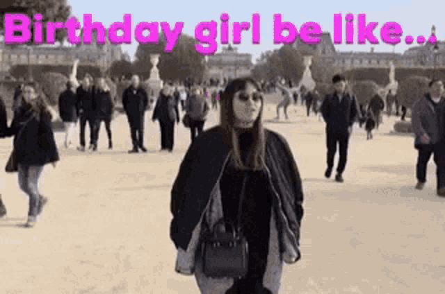 a woman is standing in front of a crowd of people with the words `` birthday girl be like '' .