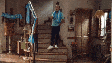 a man is standing on a set of stairs in front of a argentina banner