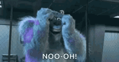 sulley from monsters inc is covering his eyes with his hands while smiling .