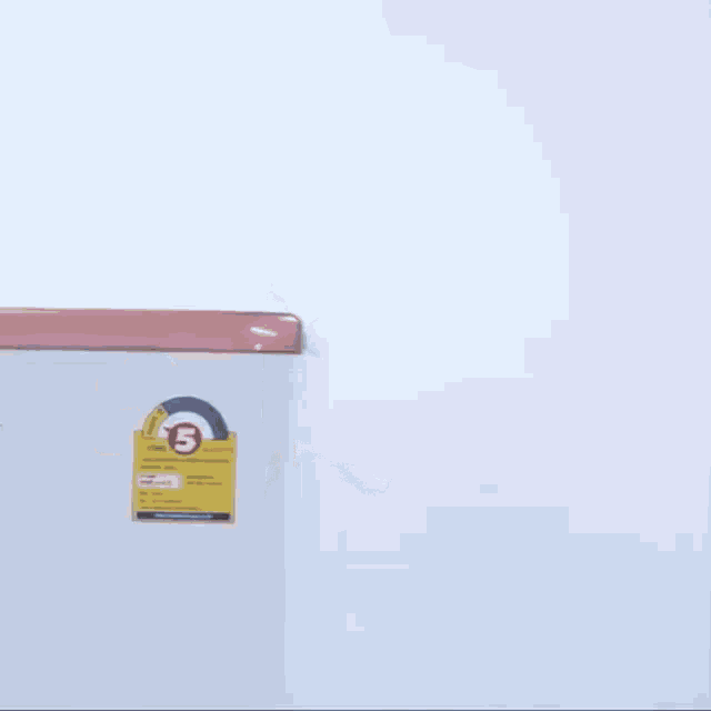 a man wearing a mask peeking out from behind a refrigerator