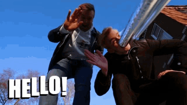 two men are standing next to each other with the words hello written in white